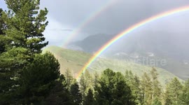 Beautiful footage of a double rainbow appearing over French Alps