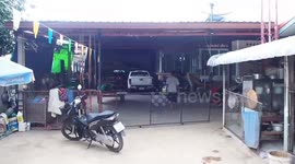 Snake wranglers ride away with reptile carried around their neck