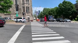 Street juggler busks in the middle of the road at red lights in Montreal