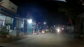 Driver has very close call in Vietnam as young child runs out in front of car at night