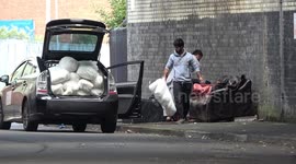Bizarre moment UK men filmed removing stuffing from fly-tipped sofas