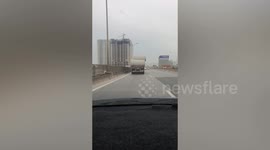 Dangerously overloaded carries concrete pipes on Vietnam highway