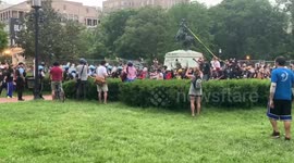 Protesters try to keep police out of area as they attempt to tear down statue