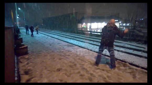 Snowball fight in heavy snow at Littleborough train station