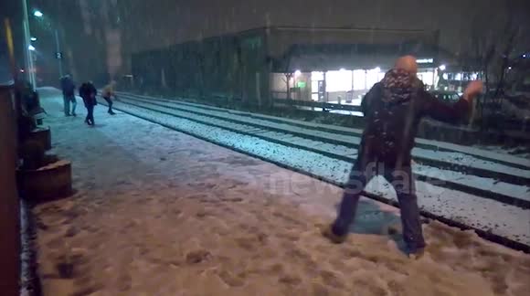 Snowball fight in heavy snow at Littleborough station