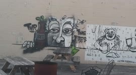 Graffiti on the back wall of a strip mall