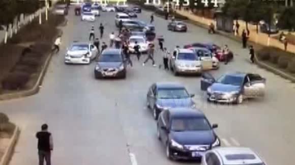 Rival armed gangs fight on a busy road in China - Buy, Sell or Upload Video Content with Newsflare