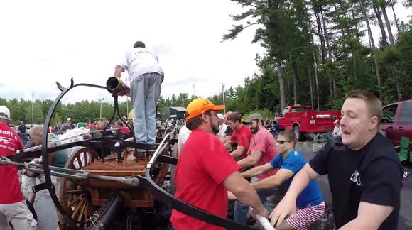 Pumping An Antique Fire Engine In Competition