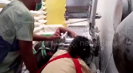 Worker gets hand stuck in noodle making machine