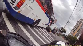 Indecisive bus driver changes direction almost crushing motorcycle rider