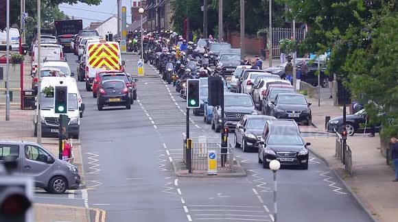 A motorcade of bikers join funeral procession of fellow biker in West Yorkshire