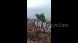 Indian health workers seen dumping bodies of coronavirus victims into mass graves