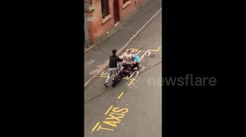 UK woman's broken down mobility scooter pushed along road by young man