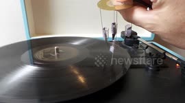 Record Played With Four Knife Blades Attached to Springs