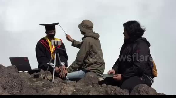 University student holds online graduation on top of active volcano in Indonesia