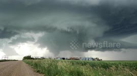 Tornado spinning over farm yard