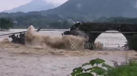Bridge dating back 400 years washed away by overflowing river during floods in China