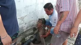 Alleged drunk man rescued after spending the night sleeping in muddy sewer in Thailand
