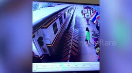 Thai woman playing on phone misses train then leaps into moving carriage