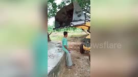 Shocking moment excavator driver knocks man down using machine arm in south India