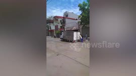 Truck gets stuck in pot hole in Vietnam