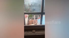 Builder Stands On Wall While Demolishing It With Mallet