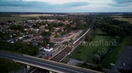 Aerial 4k clip of a high speed passenger train heading south on the East Coast mainline passing through Arlesey station in Bedfordshire UK