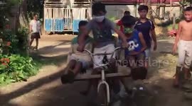 Boy takes his friend for ride on bicycle 'with wings'
