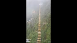 Adrenaline junkie takes on Vietnam's highest wooden suspension bridge
