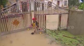 Chinese fireman dives into floodwater to open gate to evacuate stranded residents