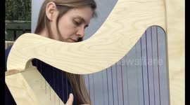 Dyslexic harpist invents new harp with rainbow strings and matching coloured sheet music to help her play