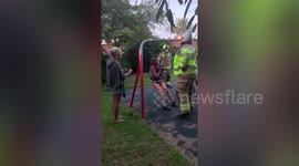 This is the moment a teenager had to be rescued by fire fighters after getting herself lodged in a baby swing