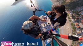 Turkish daredevil paraglides at 1,200 meters while sipping on coffee during an interview