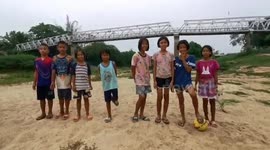 Kids use drought-hit river as football pitch in northern Thailand