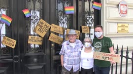 LGBT rights activists cover Polish embassy doors with signs in London