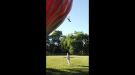 Man clings onto hot air balloon rope in terrifying Lyon street act