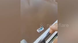 Man bemuses locals by drinking tea while floating on a plank in the Yangtze River