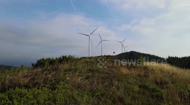 Windmill park in a sunny but windy day. This place is located in Asturias, Spain and the beuatiful landscape is in harmony with the Windmill and the green environment, such as the sustainalble future.