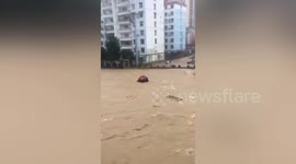 Dramatic flooding sweeps away multiple vehicles and causes five deaths in China's Hubei