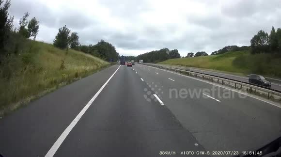 HGV Truck Lane wandering nearly wipes out a car on the hard shoulder and a woman checking on her child in the rear.