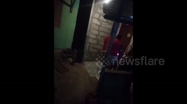 Firefighters catch cobra snake that snuck into family house in Indonesia