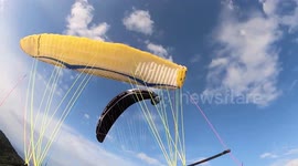 Heart pumping footage shows the moment two paragliders are involved in a mid-air collision