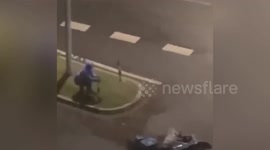 Chinese delivery man clings onto bollard to avoid being blown away by powerful winds during typhoon Hagupit