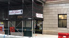 Banner at Construction site at Union Square NYC reminds Workers to Socially Distance