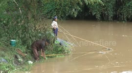 Thai villagers go fishing in swollen river after storm Sinlaku heavy rain