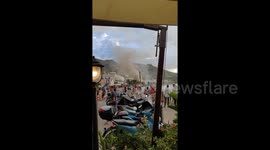 Holidaymakers run for cover as waterspout hits beach in southern Italy