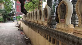 Cats Prowl Along Buddhist Temple Wall In Cambodia