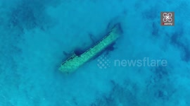 Rare drone footage of visible shipwreck lying on the side, on an exotic location