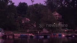 Snapped trees, sunken boats and damaged houses as storm front leaves trail of destruction in its wake