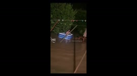 Dad rowing paddling pool down flooded back garden